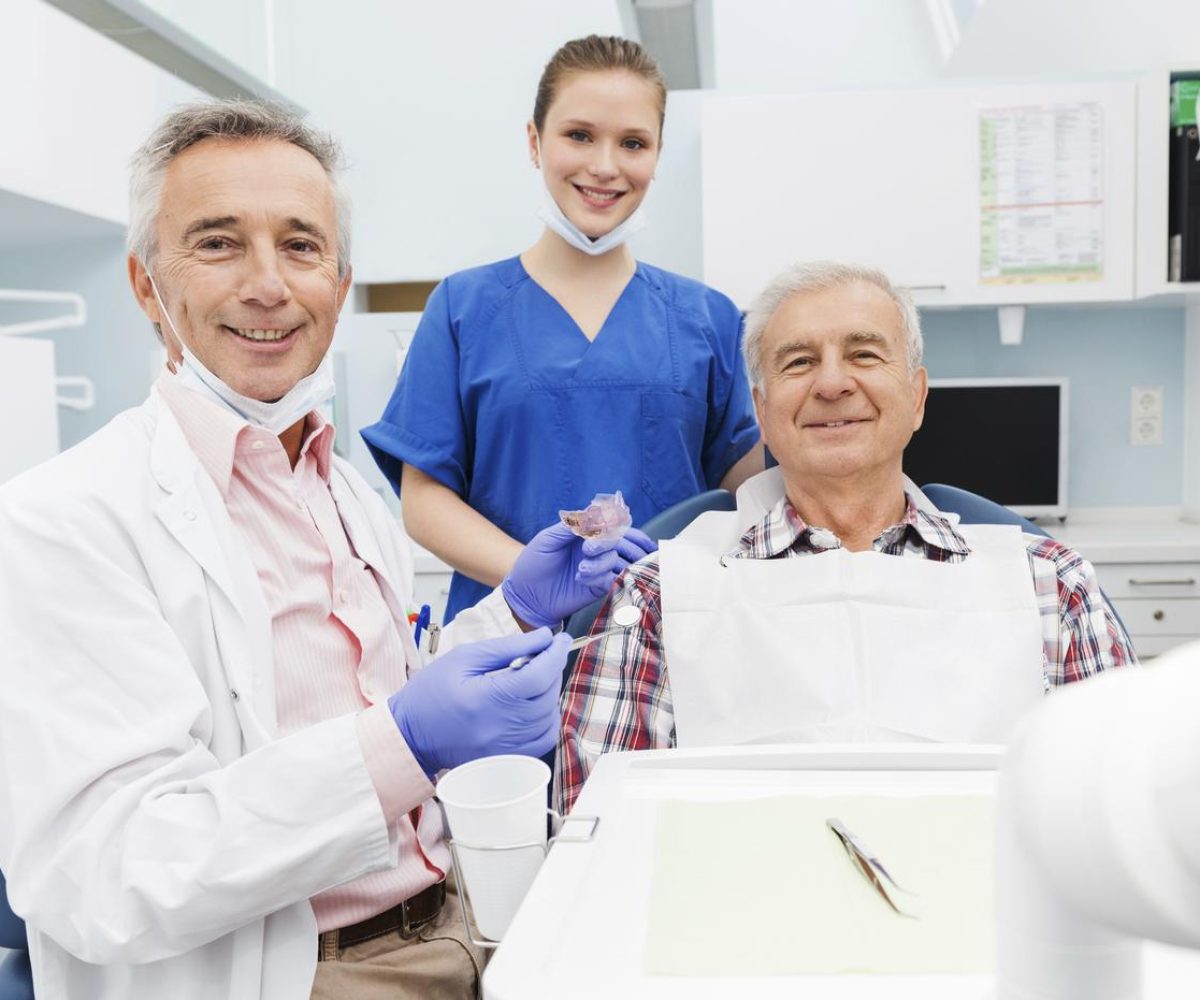 Dentist Fitting Patient With SomnoDent Fusion