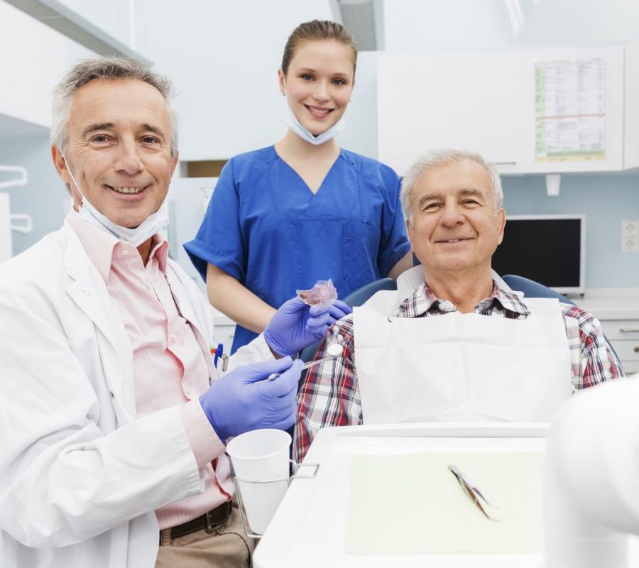 Dentist Fitting Patient With SomnoDent Fusion