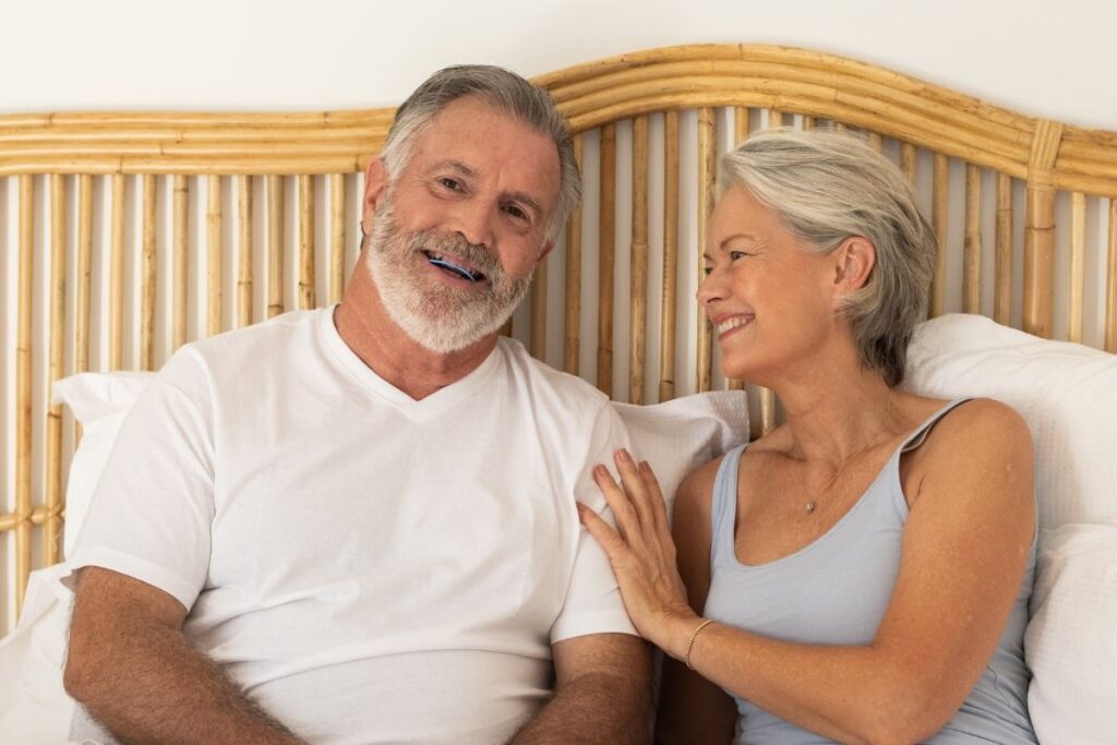Husband smiling with SomnoDent Avant and wife looking on happily image