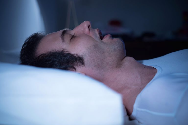 Man snoring with mouth open