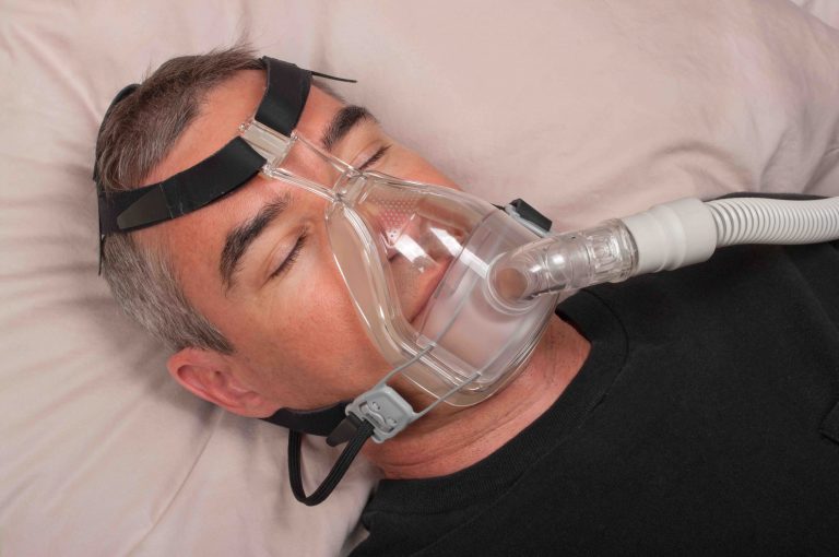 Man Sleeping With CPAP Machine